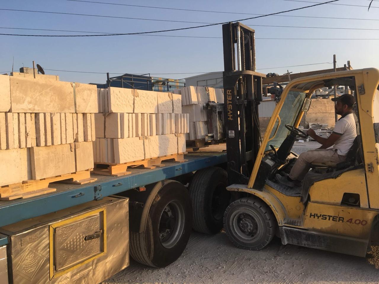 Forklift handling stone blocks